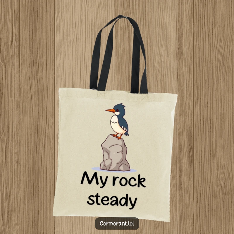 Funny Cormorant Tote Bag: A kawaii cormorant bird balances precariously on a single, wobbly rock, illustrating a funny challenge.